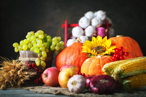 Happy Thanksgiving Day background, wooden table decorated with Pumpkins, Maize, fruits and autumn leaves. Harvest festival. Selective focus. Horizontal. - Photo, image