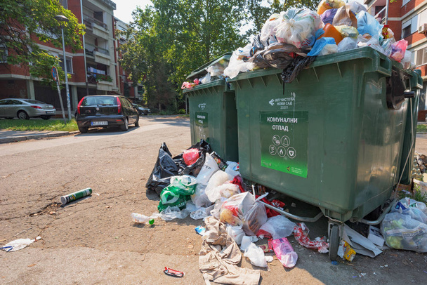 NOVI SAD, SERBIA - AUGUST 18, 2018: Municipal solid waste or communal garbage is overflowing containers in Novi Sad during weekends, illustrative editorial - Foto, Bild