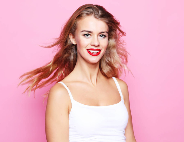 lifestyle, fashion concept: beautiful young woman wearing casual clothes, posing on pink background - Photo, Image
