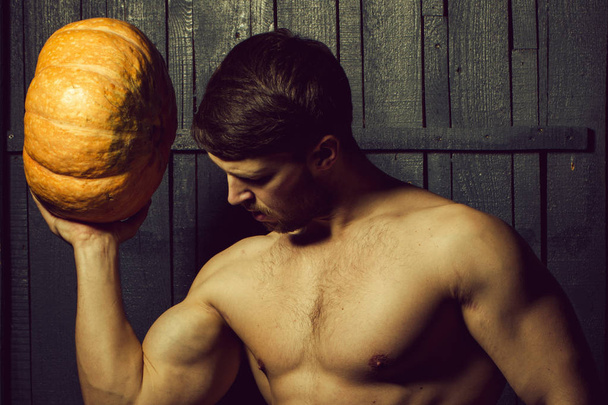 Muscular boy with pumpkin - Fotó, kép