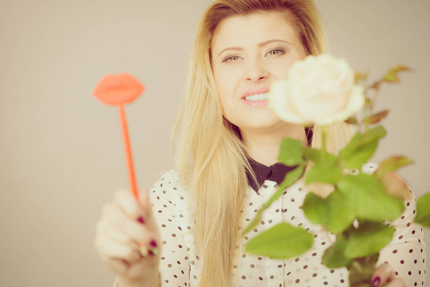 Happy positive woman holding white roses and red lips on stick. Valentines and womans day gift ideas concept. - Φωτογραφία, εικόνα