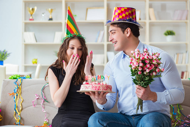 Young couple celebrating birthday with cake - Fotografie, Obrázek