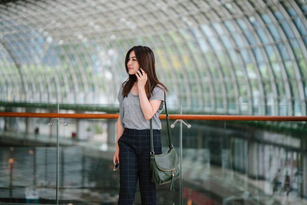 attractive young asian woman talking smartphone  - Фото, изображение