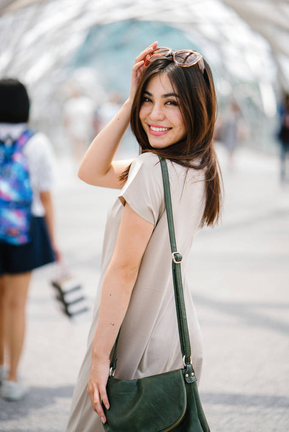 Happy attractive young asian woman walking on the street  - Photo, Image