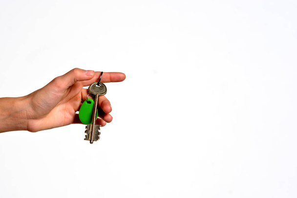 House key with trinket house in the female palm. Rental estate. Sale property template. - Fotó, kép