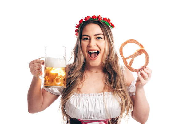 Attractive girl in traditional german costume with pretzel and beer on Oktoberfest, isolated on white - Φωτογραφία, εικόνα