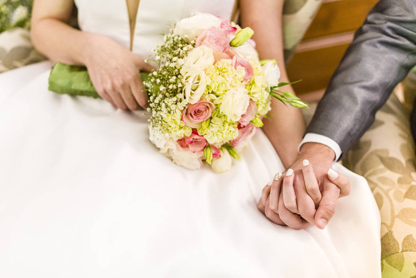 Groom holding bride's hand during wedding party - Photo, Image