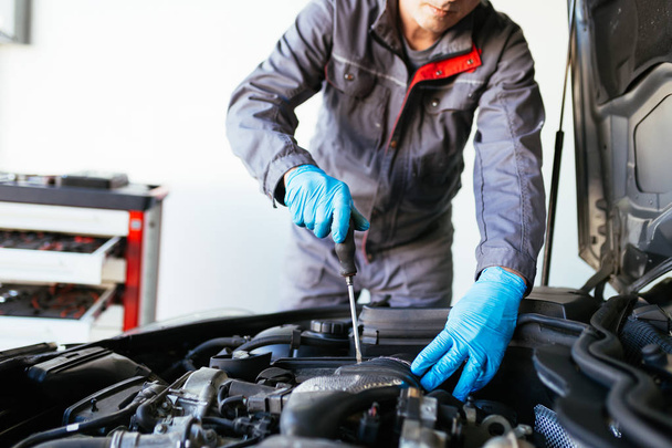 Auto mechanic repairing car. - Фото, зображення
