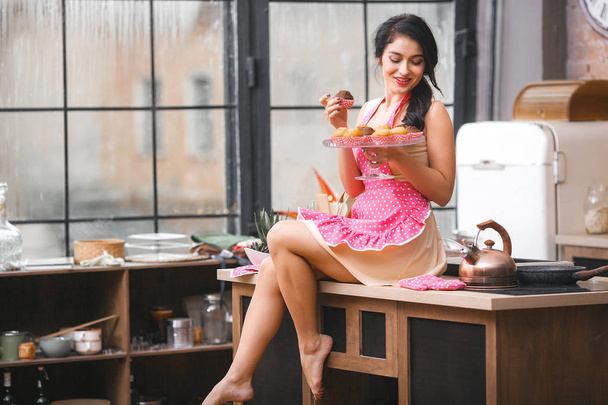 Attractive young woman baking in the kitchen - 写真・画像