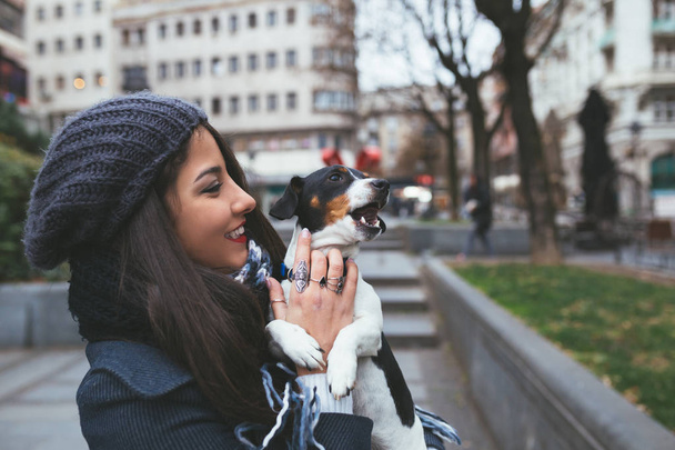 fashionable  young girl with dog on the street - Zdjęcie, obraz