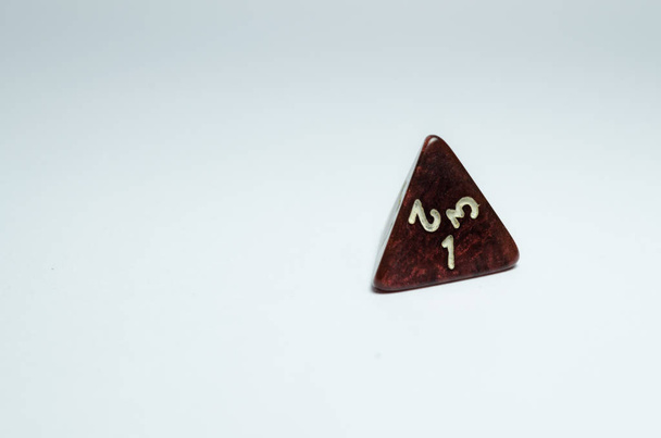 red four-sided dice, isolated on a white background. Dice of role playing game and dungeons and dragons. - Photo, Image