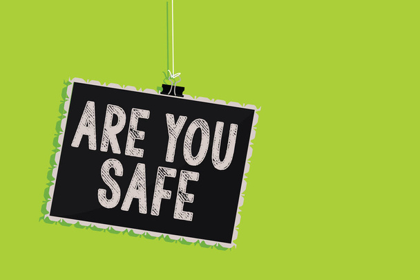 Conceptual hand writing showing Are You Safe. Business photo text Free from danger Not anticipating any Harm Hurt physically Hanging blackboard message communication sign green background - Photo, Image