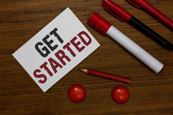 Writing note showing Get Started. Business photo showcasing asking someone to begin task endeavour or process right now White paper markers wooden background communicating ideas messages - Photo, Image