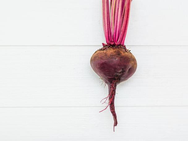 Fresh red beetroot on a white wooden table. Health food. Vegetarian food. The view from the top. Flat lay. - Photo, Image