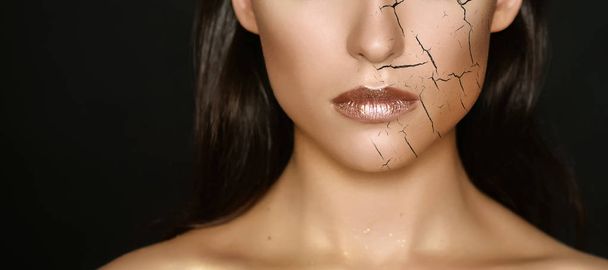 Woman with cracked on face as cosmetic and dehydration effect concept. - Foto, Imagen