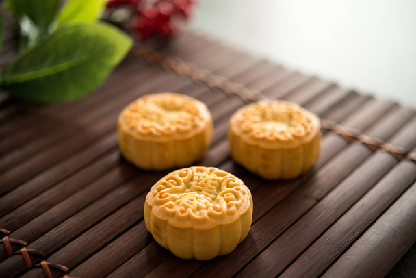 Moon cakes is traditionally pastry to eaten during Mid-Autumn Festival. The Chinese character on the mooncake represent "lotus paste" in English. - Photo, image