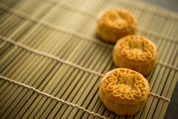 Mooncakes is traditionally baked pastry to eaten during Mid-Autumn Festival. The Chinese character on the moon cake represent "lotus paste" in English. - Photo, image