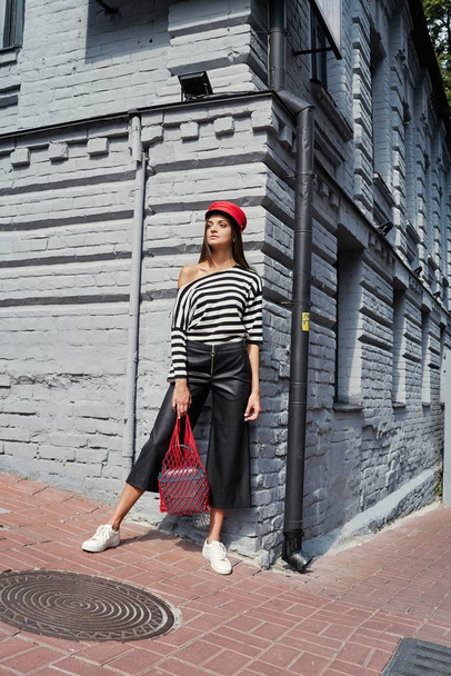 stylish female fashion model posing on the street  - Фото, зображення