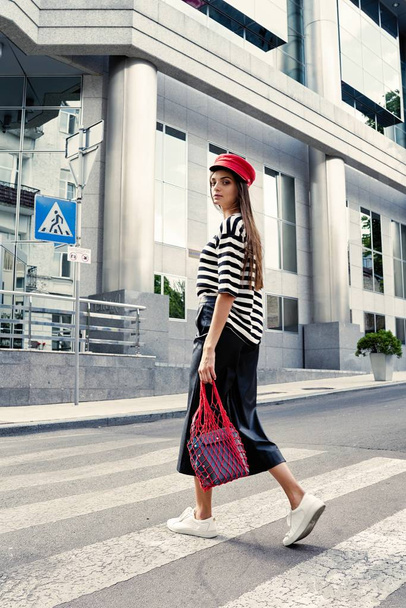stylish female fashion model posing on the street  - Photo, image