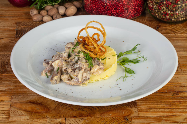 Tasty beef stroganoff with mashed potatoes and herbs - Photo, Image