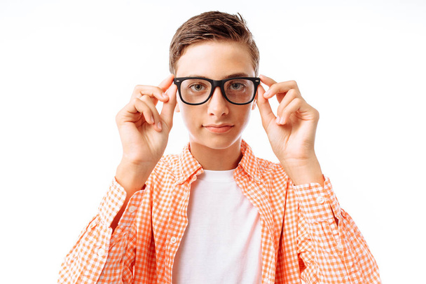 Closeup portrait of teenage boy with glasses, smiling face, in Studio on white background - Zdjęcie, obraz