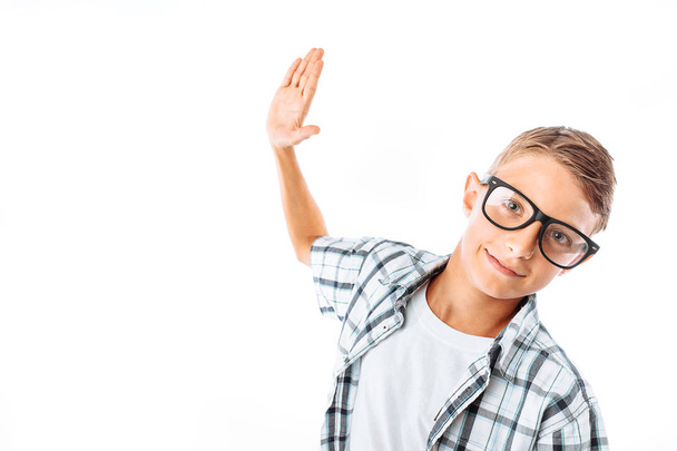 Young handsome man in glasses swinging his hand to give five, nerd in Studio - Foto, Bild