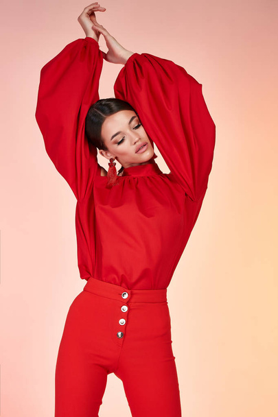 Pretty beautiful sexy elegance woman fashion model glamor pose wear red color trousers silk blouse clothes for party summer collection makeup hair style brunette success accessory bag jewelry studio. - Foto, Bild