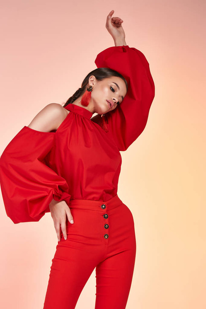 Pretty beautiful sexy elegance woman fashion model glamor pose wear red color trousers silk blouse clothes for party summer collection makeup hair style brunette success accessory bag jewelry studio. - Foto, Bild
