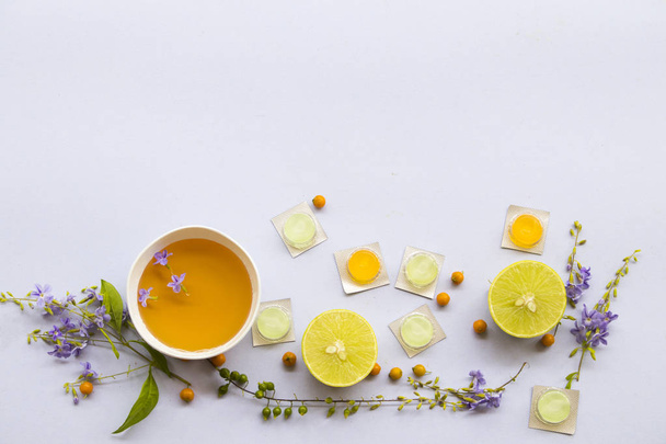 cough sore throat pastille pills from herbal honey lemon with purple flowers arrangement on background white - Foto, Imagen