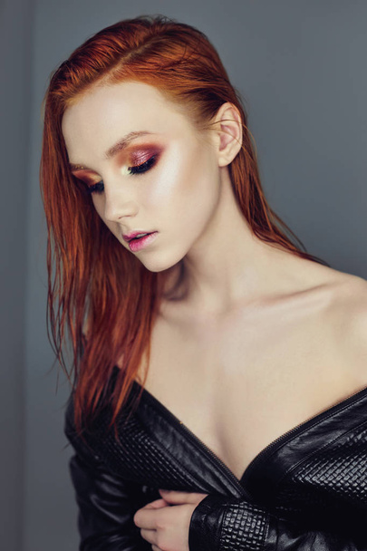 Portrait profile of a woman's face with red bright hair. Hair coloring, color. Naked girl in a black leather jacket. Perfect makeup on your face - Φωτογραφία, εικόνα