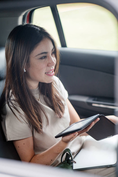 Beautiful young asian woman  in  car using tablet - Photo, Image