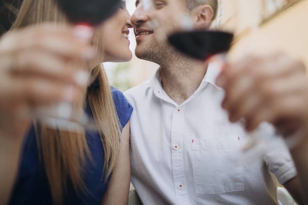 Young couple with glasses of red wine in a restaurant .  - Foto, imagen