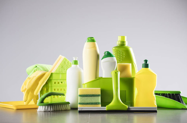 House and office cleaning up theme.  Set of colorful cleaning products on gray background. Place for logo, text or typography. - Photo, Image