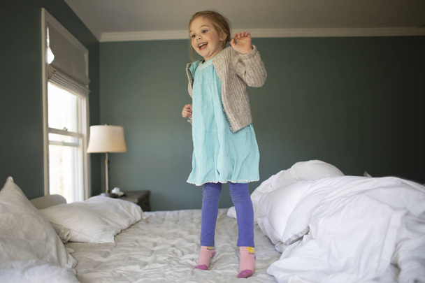 Child jumping on a bed - Photo, Image