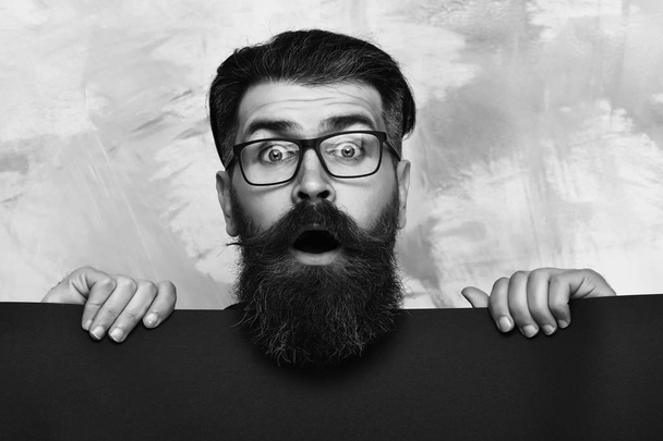 bearded man with surprised face in glasses on colorful background - Foto, imagen