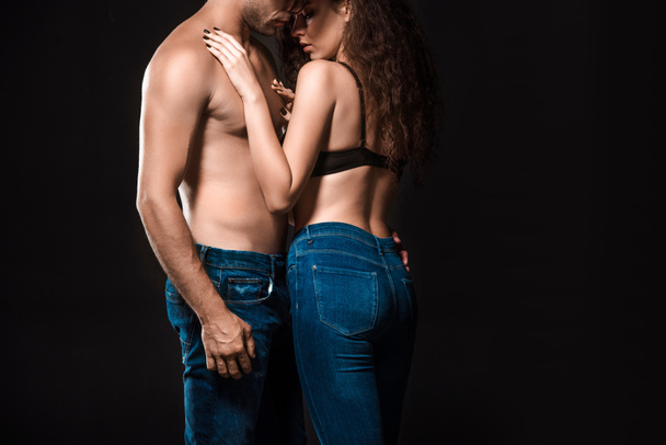 partial view of sexy shirtless couple hugging isolated on black - Photo, Image