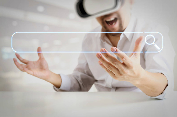 Searching Browsing Internet Data Information Networking Concept with blank search bar.businessman wearing virtual reality goggles in modern office with Smartphone using with VR headset - Photo, Image