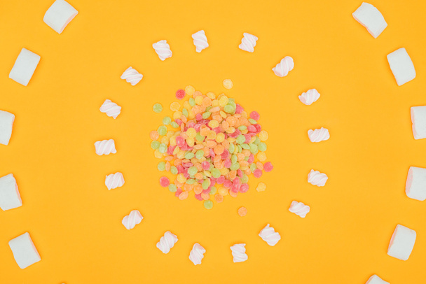 vista dall'alto di cerchi di caramelle gelatina e marshmallow isolati su arancione
 - Foto, immagini