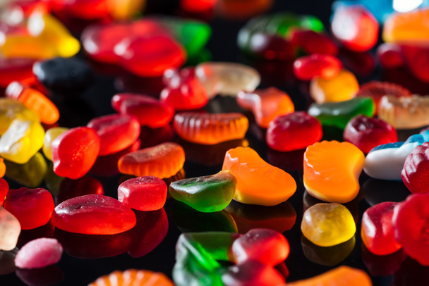 tasty bright jelly candies on black surface - Photo, Image