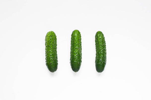 Fresh cucumber pattern. Whole cucumbers on white background. Top view, flat lay. Food concept. - Φωτογραφία, εικόνα