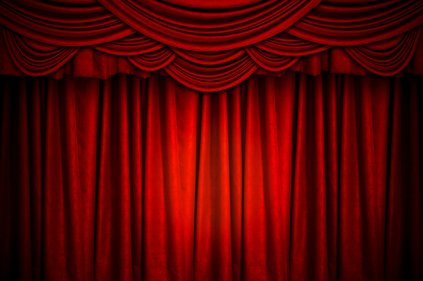 Rode gesloten gordijn met lichte vlekken op het toneel voor de achtergrond. - Foto, afbeelding