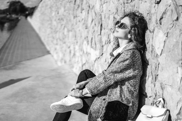Monochrome photo of young girl with curly hair relaxing outdoor - Φωτογραφία, εικόνα
