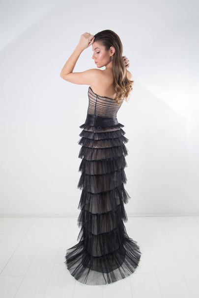 Side View Of Beautiful Fashion Woman With Long Blond Hair Slicked Back And Perfect Makeup Posing In Gorgeous Evening Tulle Dress, Full-Length Studio Shot - Φωτογραφία, εικόνα