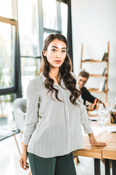 portrait of beautiful asian businesswoman standing at workplace in office - Valokuva, kuva