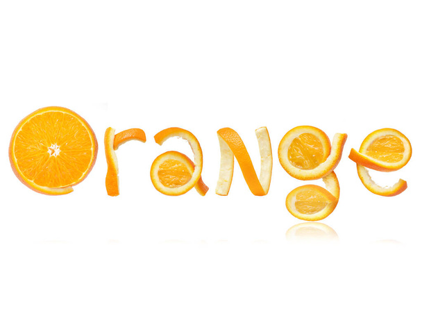 The word orange is made of peel on white background - Zdjęcie, obraz