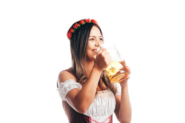 Bavarian woman celebrating the oktoberfest isolated on white background - Photo, image