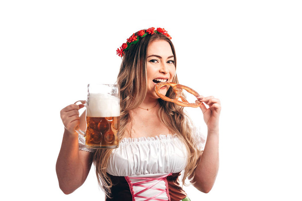 Attractive girl in traditional german costume with pretzel and beer on Oktoberfest, isolated on white - Foto, imagen