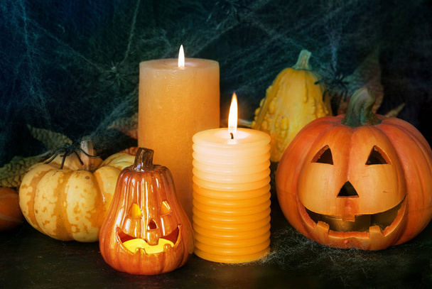 Halloween pumpkin decor with candle and spiders - Photo, image