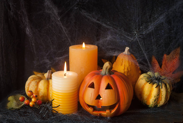 Halloween pumpkin decor with candle and spiders - Photo, image