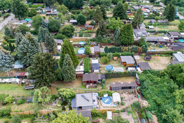 Aerial photo with the drone, a new build-up plot with single houses and gardens, narrow neighbourhood - Photo, Image